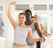 © JackF - Group ballet rehearsal - men and women stand in third position near ballet barre during group training in a dance studio