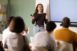 © JackF - Young woman teacher gives lecture to multinational group of students in lecture hall