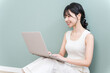 © buritora - Young Asian woman using a computer in her room (video, side job, SNS, work from home)