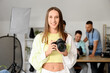 © Pixel-Shot - Female photographer with camera during courses in studio