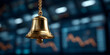 © sornram - A close-up of a golden bell hanging in front of financial market screens, symbolizing trading and investment activities.