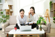 © Nuttapong punna - Two professional businesswomen working together with laptop, coffee and smartphone at home office. Remote work, startup teamwork, modern business lifestyle.
