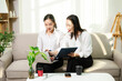© Nuttapong punna - Two professional businesswomen working together with laptop, coffee and smartphone at home office. Remote work, startup teamwork, modern business lifestyle.
