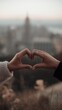 © Henry K - Romantic Couple Hands Forming Heart Shape Over City Skyline