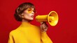 © MarkelovaVision - Woman with a megaphone on a red background