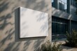 © diproduction - Blank rectangular sign mock up mounted on concrete wall outside modern building in natural daylight with shadows and plants in view. Ai generative