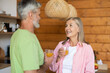 © zinkevych - Senior pair sharing morning drink and warm communication in kitchen