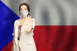 © artmim - Confident woman in medical mask showing stop gesture open palm hand against flag of Czech Republic background