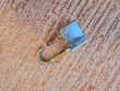 © Muhammad - ​Broken silver padlock with a rusted, cut shackle lying on a textured ground. Concept of security breach, burglary, theft, and failed safety protection