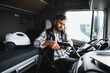 © Serhii - Trucker cleaning truck cab interior with steam cleaner