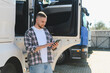 © Serhii - Young truck driver using smartphone at semi truck