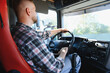 © Serhii - Truck driver steering road haulage vehicle cabin