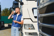 © Serhii - Truck driver drinking coffee having break at parking
