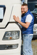 © Serhii - Happy truck driver hugging cargo transport vehicle