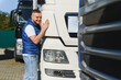 © Serhii - Young male truck driver expressing love for job
