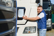 © Serhii - Happy truck driver hugging logistic vehicle