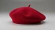 ©  Aktaruzzaman - A vibrant red beret on a plain background