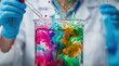 © NN AI - Scientist dropping liquid into beaker with colorful ink splashes. Chemistry experiment with vibrant swirling dyes in laboratory. Research and discovery concept