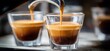 © Aquir - Espresso machine pouring hot coffee into glass cups. Espresso machine pouring fresh coffee with rich crema into two small glass cups