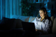 © PheelingsMedia - Serious woman using personal computer in the night at home