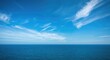 © AbstractAI - Bright blue sky gently meeting the ocean surface with thin clouds and a clear horizon