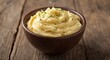 © vxnaghiyev - Closeup of homestyle mashed potato bowl sitting on weathered wooden surface