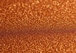 © MdMashud - Close up macro view of sparkling copper glitter with a subtle horizontal stripe of darker tones