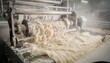 © DigitalSpace - Medium shot capturing softwood mix pulp refining and stock flow in paper machine showcasing the mechanical treatment and fiber blending for durable paperboard sheets.