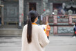 © leungchopan - Woman praying inside traditional temple with incense