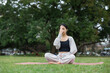 © leungchopan - Woman perform pranayama yoga in park