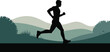 © Nasima - Silhouette of a man running through a green landscape