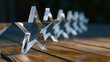© Curioso.Photography - Transparent star shaped awards lined up on table in corporate setting