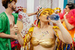 © kleberpicui - Woman drinking water during carnival street festival, showing hydration, health and self care during summer celebration