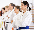 © JackF - Female team of young martial arts athletes is standing in gym, public shoot, sports training camps. Preparation for competitions, sports as way of life.........