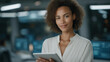 © FrameYesil - Young multiethnic female government employee using a digital tablet in a high-tech system control monitoring center, surrounded by illuminated data screens, cybersecurity dashboards, and futuristic