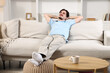 © New Africa - Man resting on comfortable sofa at home