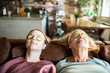 © Geber86 - Senior woman and young woman enjoying home spa day on couch