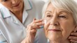 © Diana - Caring Nurse Applying Cream to Senior Woman's Face with Gentle Touch