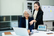 © Nuttapong punna - Businesswomen work and discuss their business plans. A Human employee explains and shows her colleague the results paper in modern office.