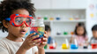 © 10kDesignsOnline - Amazed Young Scientist Doing Colorful Classroom Science Experiment