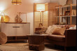 © Pixel-Shot - Interior of living room with bookshelf, sofa and glowing lamps in evening