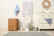 © Pixel-Shot - Interior of stylish restroom with ceramic toilet bowl, dresser and wicker basket
