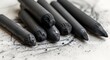 © Vector Flare - Textured charcoal drawing sticks resting on art paper, showcasing essential carbon art supplies for sketching, shading, and creating expressive monochrome artwork