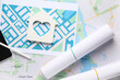 © Pixel-Shot - House figure with zoning plans on city map, closeup