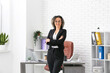 © Pixel-Shot - Happy mature businesswoman in eyeglasses near workplace in modern office