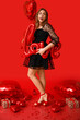 © Pixel-Shot - Young woman with word LOVE made of balloons on red background. Valentine's Day celebration