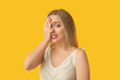 © Pixel-Shot - Young woman doing facepalm on yellow background