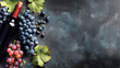© Anoo - Wine bottle and grapes are arranged on a dark surface. The flatlay shows details of the wine and grapes with room for text to enhance any wine-related material