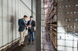© Westend61 - Two men in automatized high rack warehouse looking at tablet