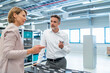 © Westend61 - Businessman and businesswoman talking in a modern factory hall